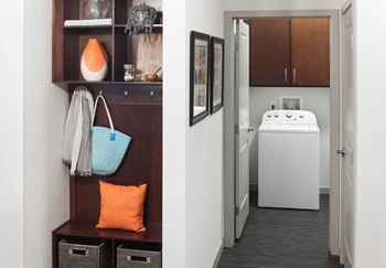 A bathroom with a white sink and a brown cabinet at Regatta Sloans Lake Apartments, Denver, Colorado